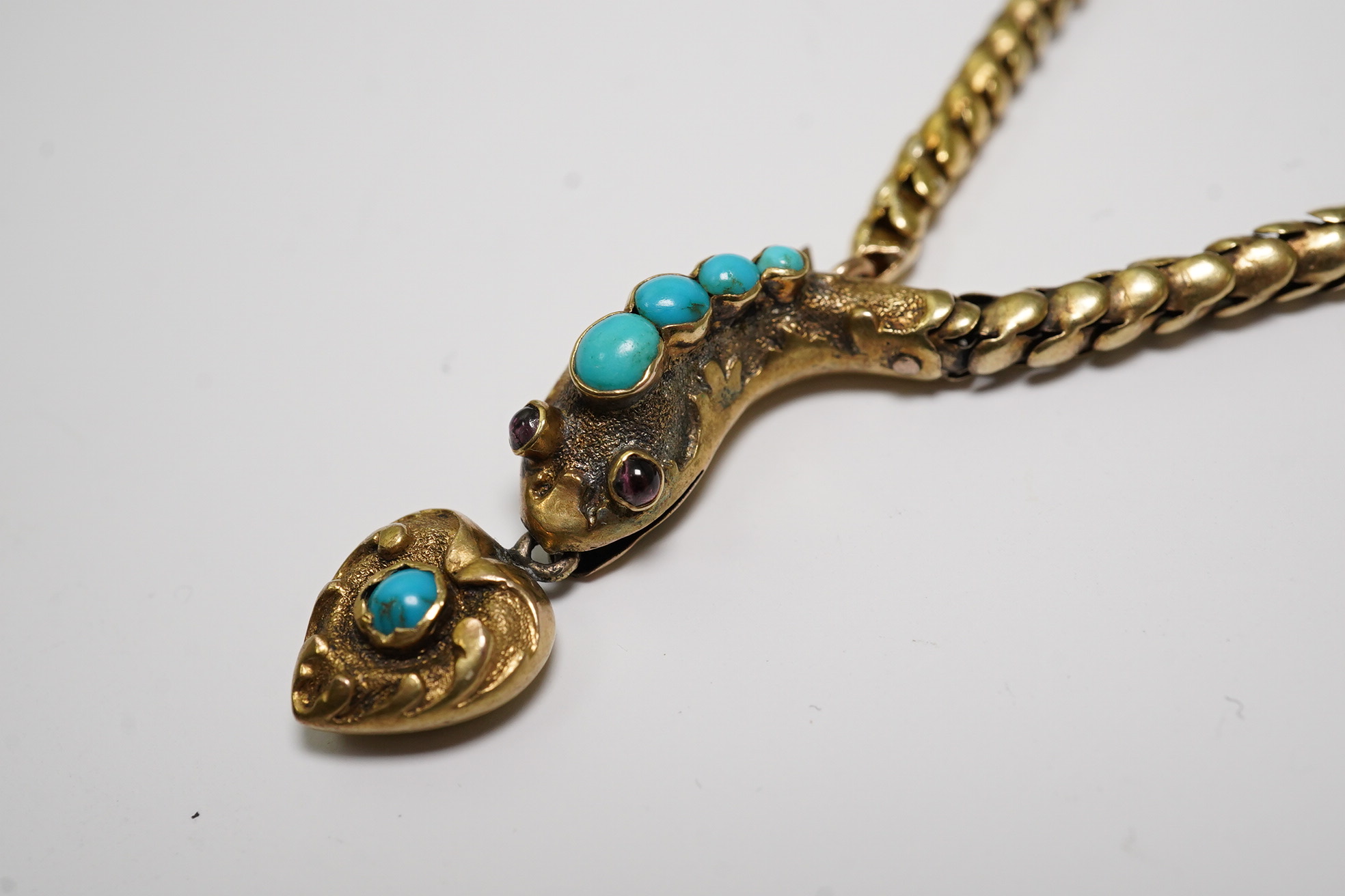 A Victorian gold, turquoise and cabochon garnet set serpent necklace